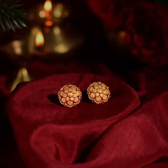 Gold Earrings with Laxmi Idol and Ruby Pota Accents